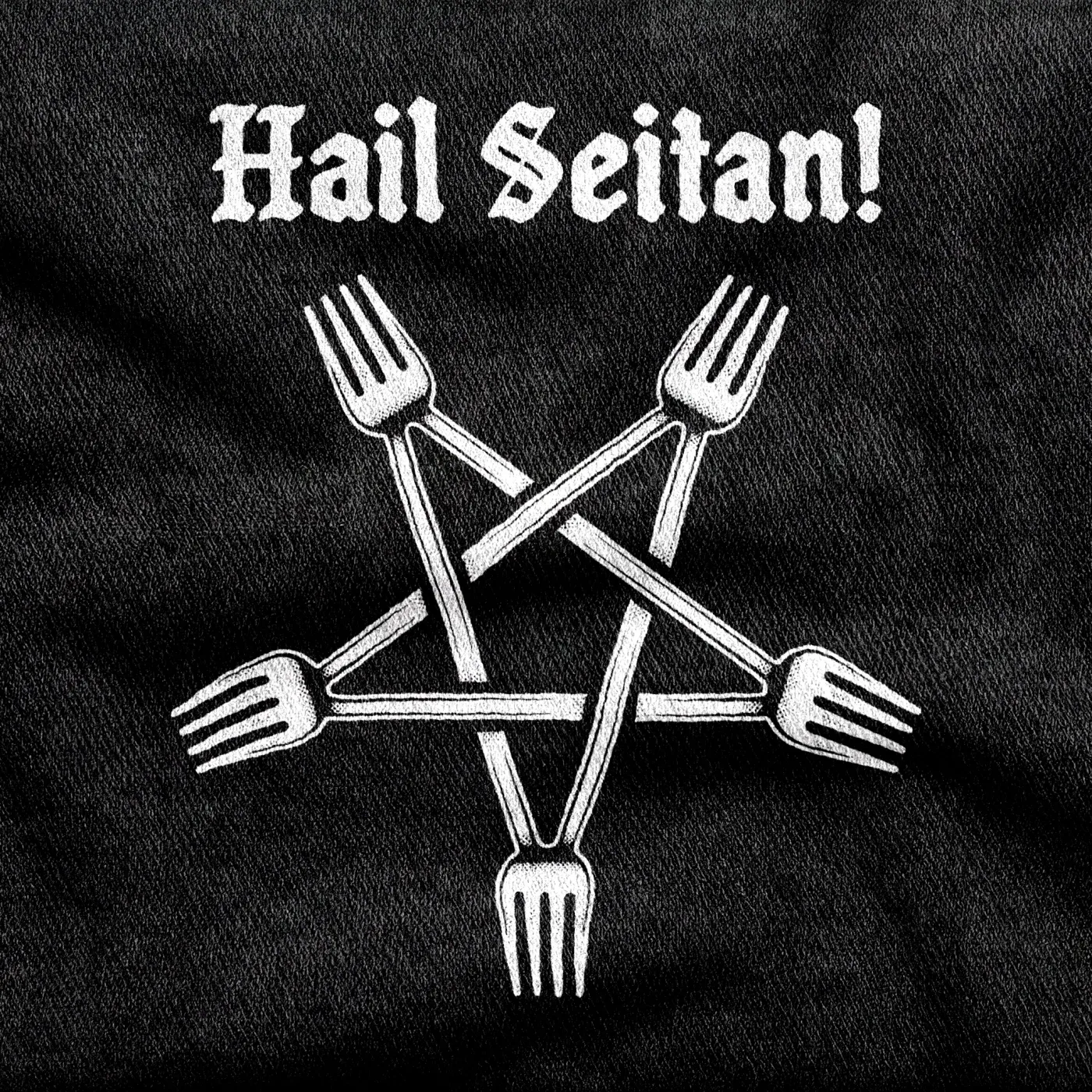 Five forks arranged into an inverted pentagram below blackletter text reading "Hail Seitan!", white on a black tee.