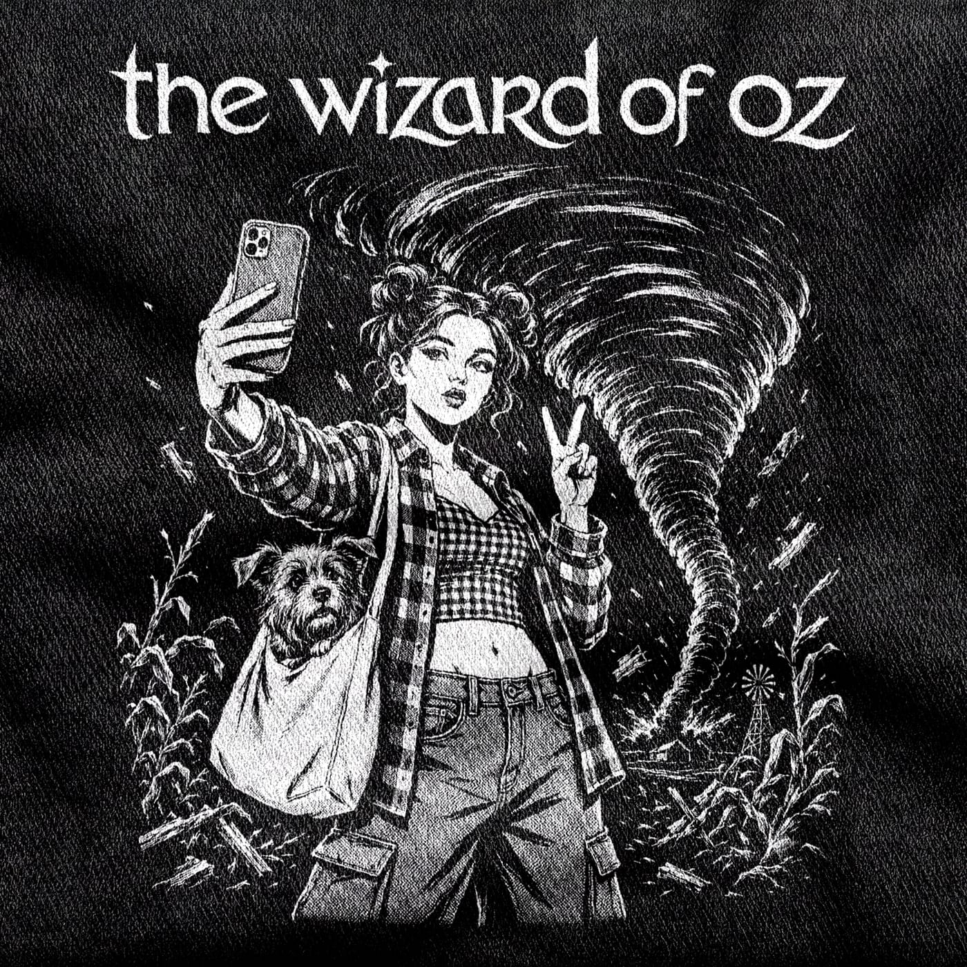 Dorothy in space buns and an open flannel over gingham, taking a selfie with Toto in a tote bag while a tornado tears up the farm behind her, white on a black tee.
