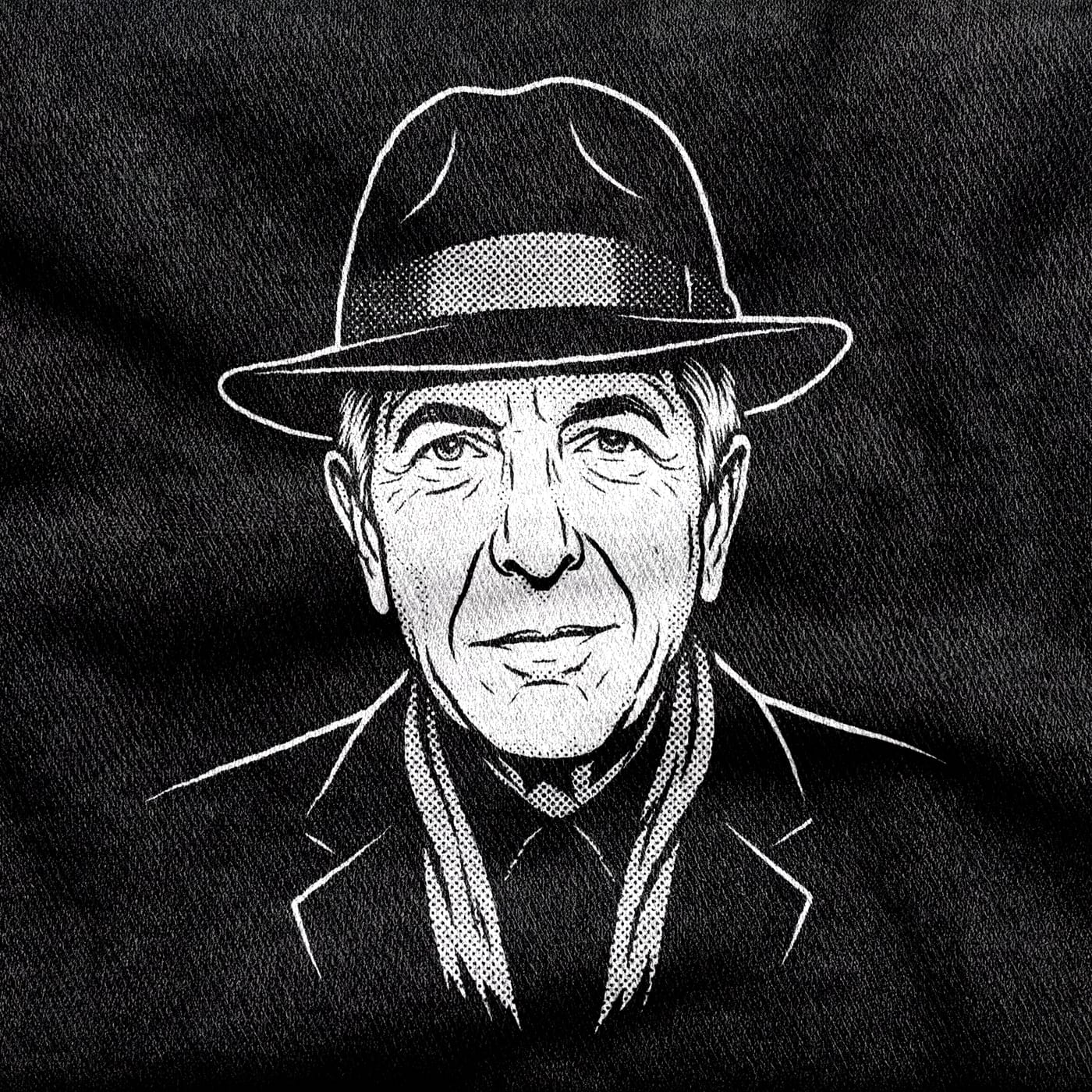 A portrait of Leonard Cohen in fedora, scarf and suit, his face deeply lined, white on a black tee.