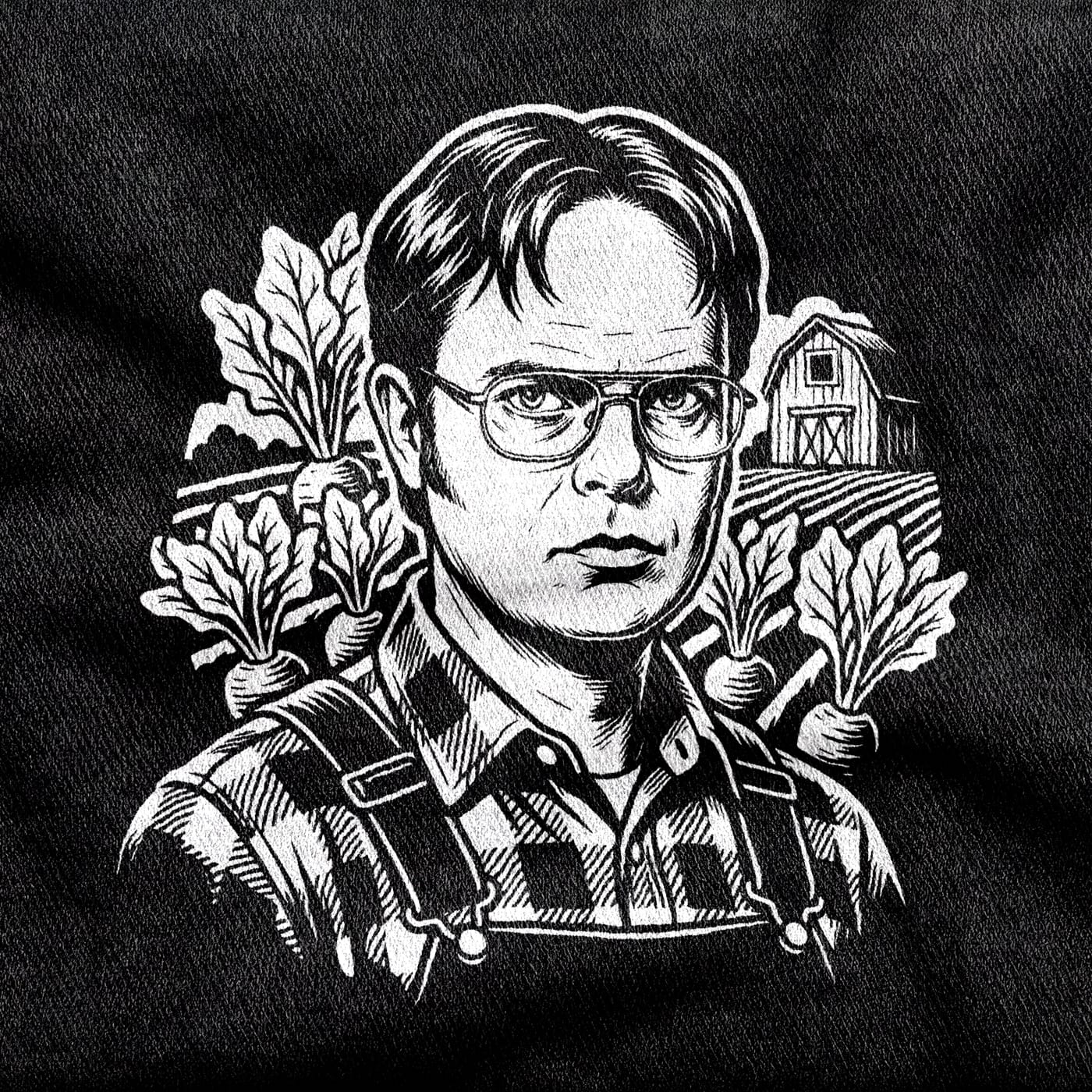 Dwight Schrute in glasses, shirt and suspenders, staring dead ahead with beet rows, a barn and ploughed fields behind him, white on a black tee.