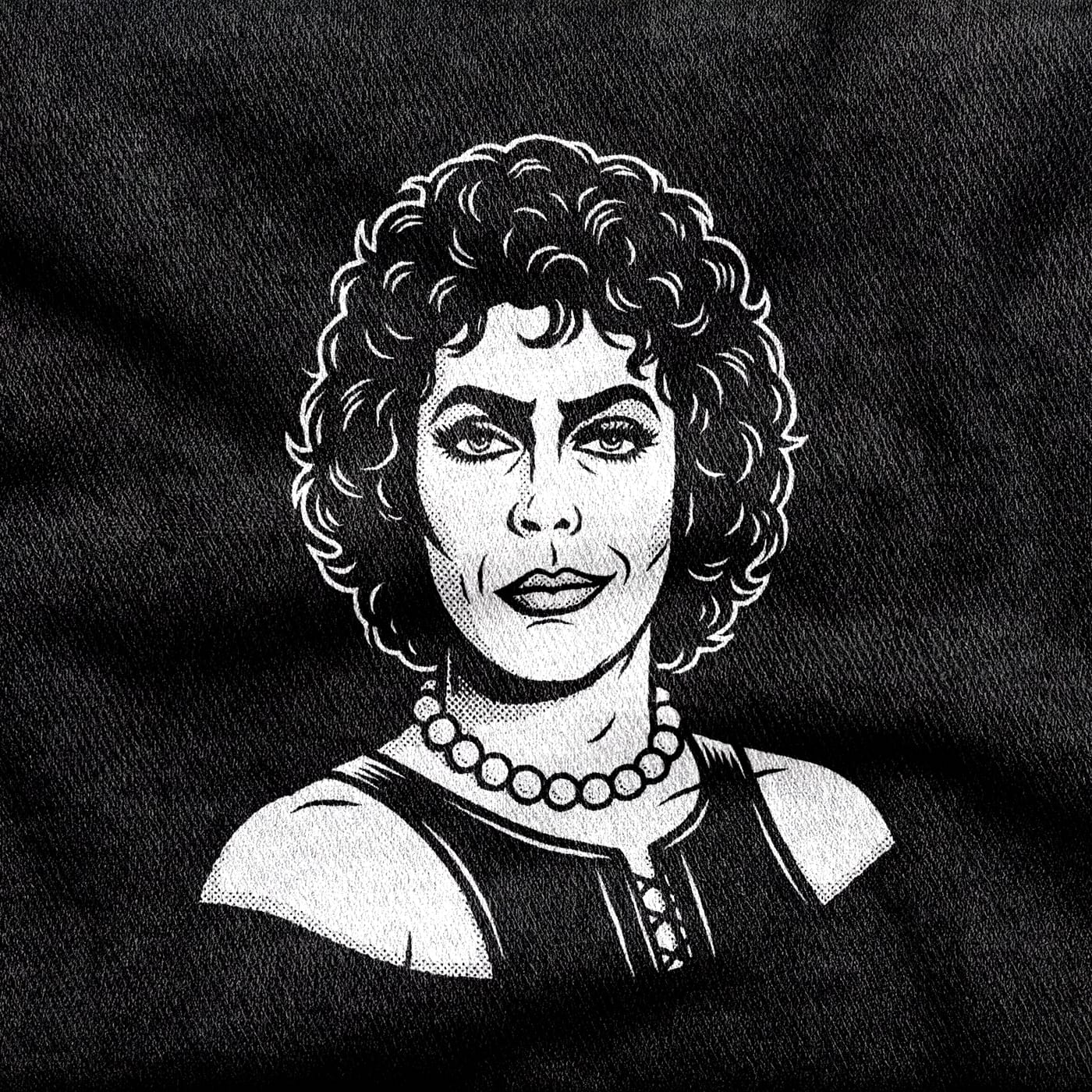 Frank-N-Furter in pearls and a boned corset, shoulders bare and eyes heavily made up, looking directly out, white on a black tee.