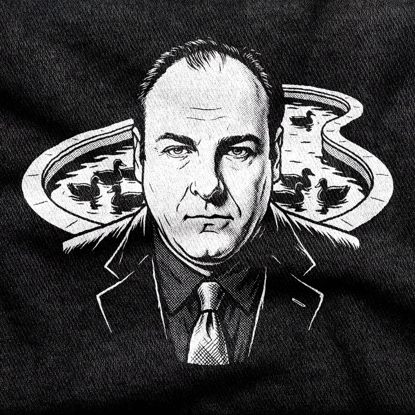 Tony Soprano in suit and tie staring dead ahead, flanked by the pool and its ducks, white on a black tee.