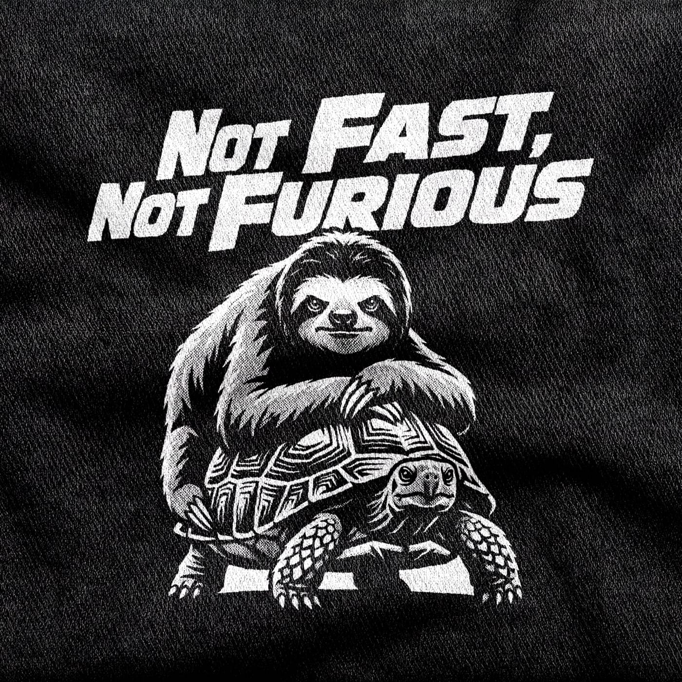 A sloth riding on the back of a tortoise, both content, under the title "Not Fast, Not Furious" in racing italics, white on a black tee.