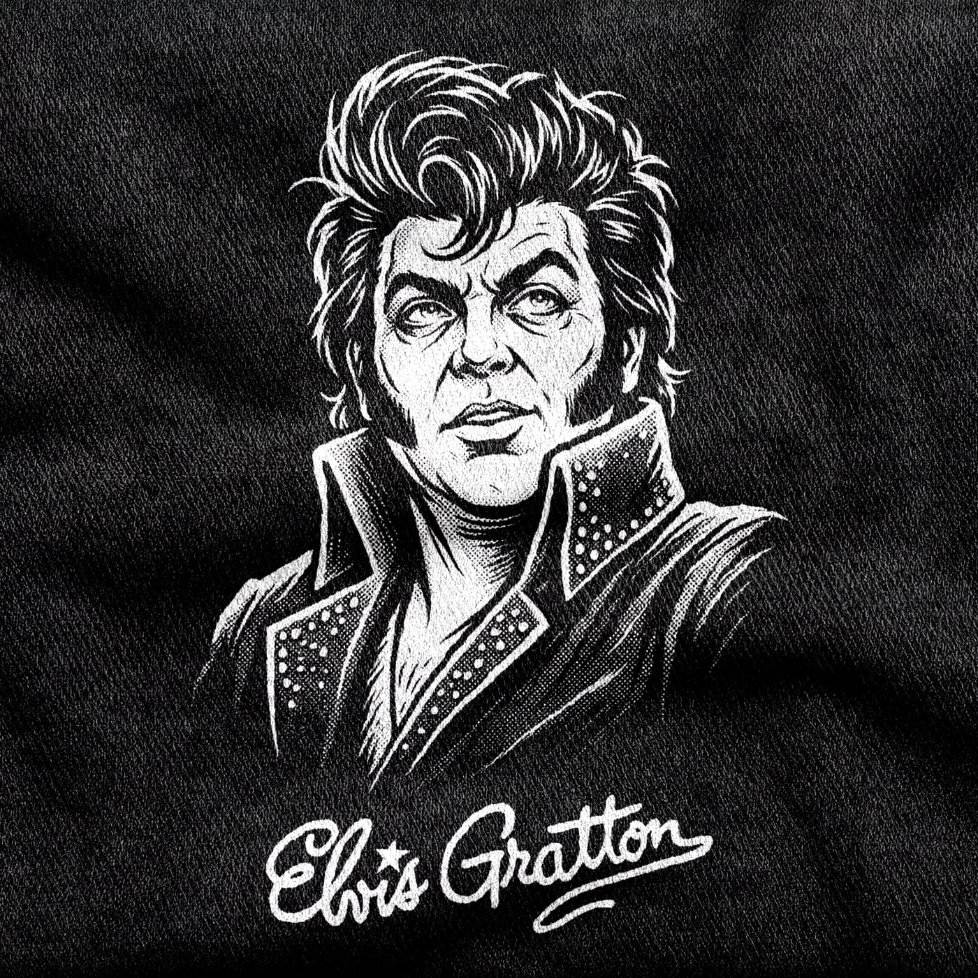 Elvis Gratton with his pompadour, jowls and rhinestone-studded collar, over a signature-style wordmark, white on a black tee.