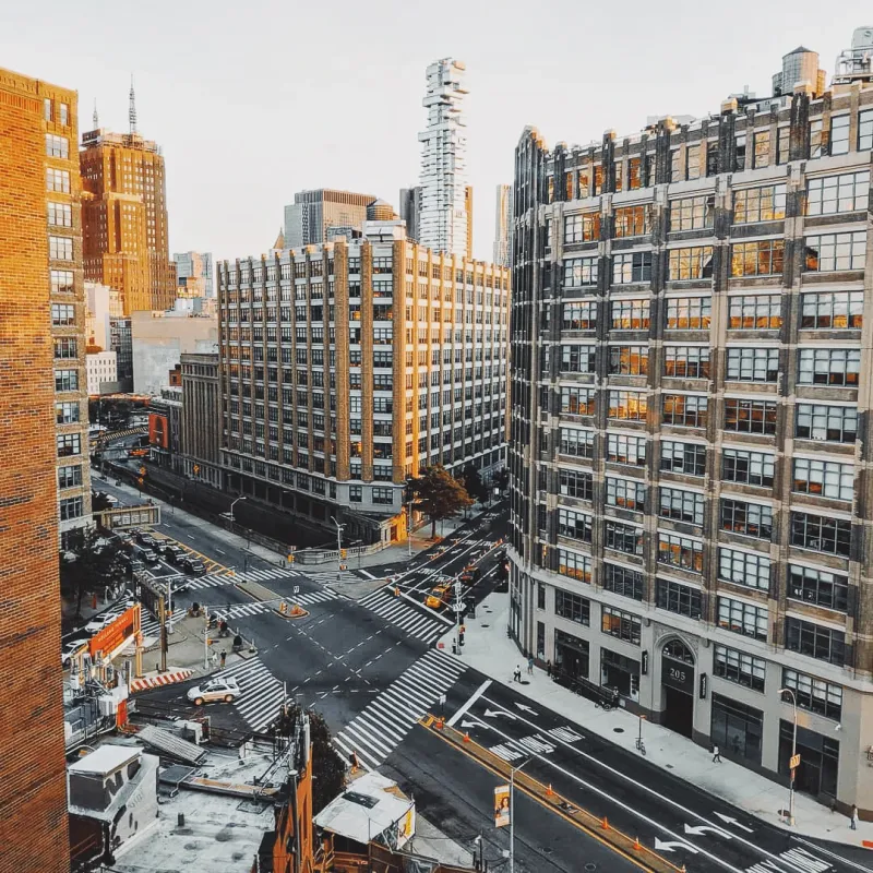Aerial view of a busy New York City intersection with construction scaffolding and pedestrian crossings