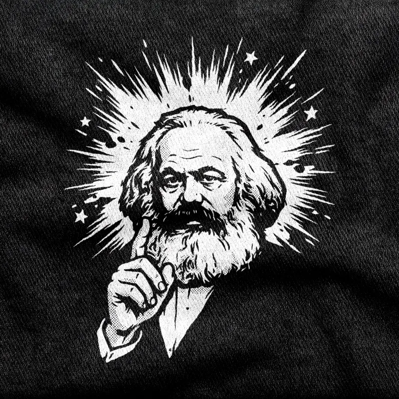A bust of Karl Marx in a starburst, the "Marx My Words" pun, white on a black tee.