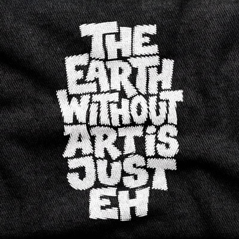 Soft chunky hand-drawn capitals stacked into a block reading "The Earth Without Art is Just Eh", white on a black tee.