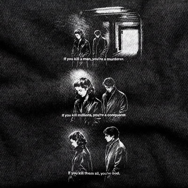 Three charcoal-soft stills from Masculin Féminin stacked down the chest, each carrying one line of dialogue, white on a black tee.